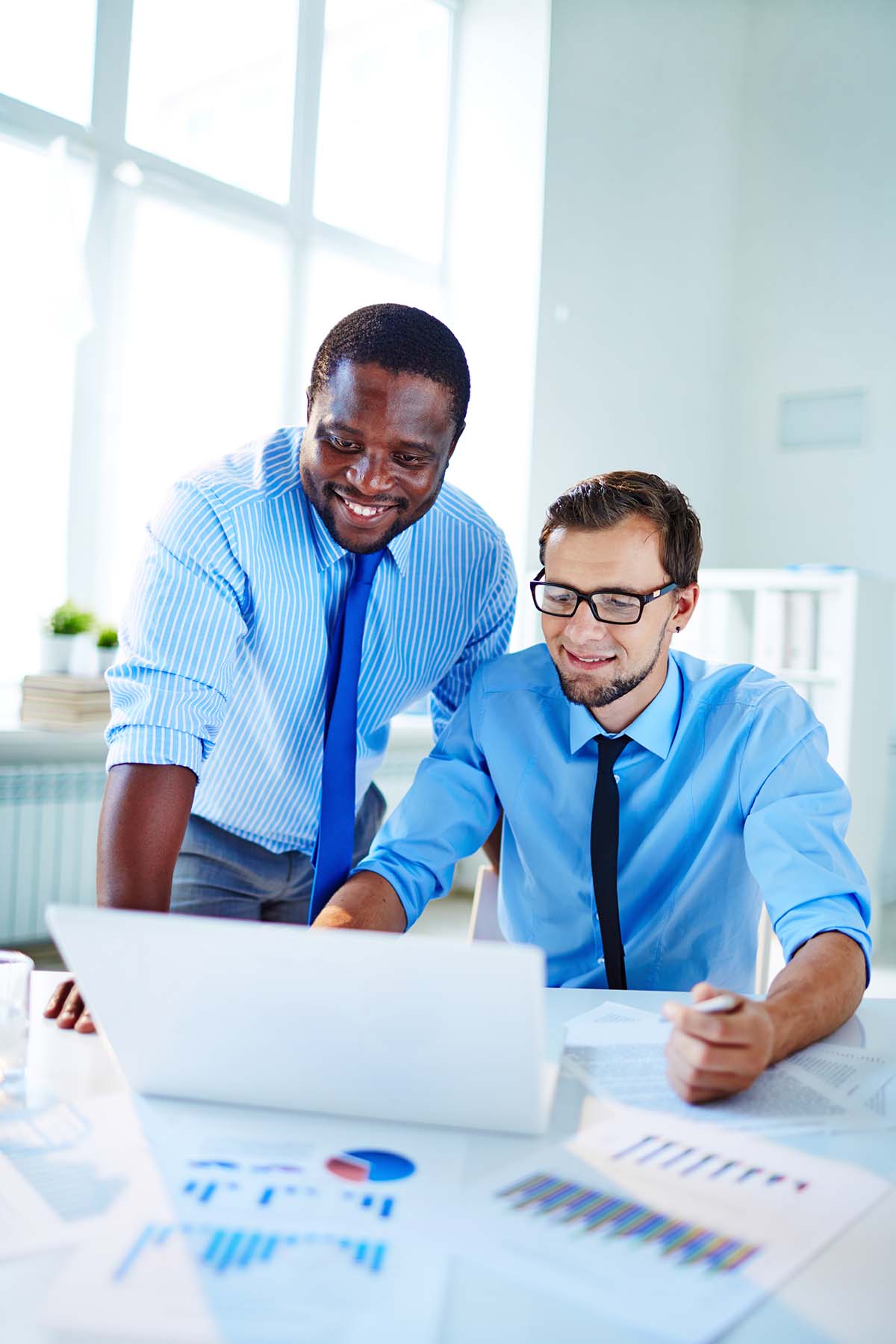 Colleagues reviewing monitoring insights at a laptop