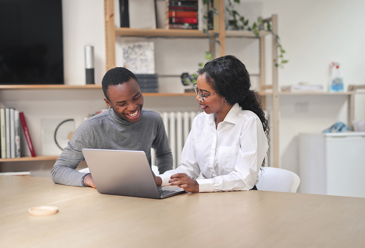 Two colleagues reviewing strategy plans on a laptop
